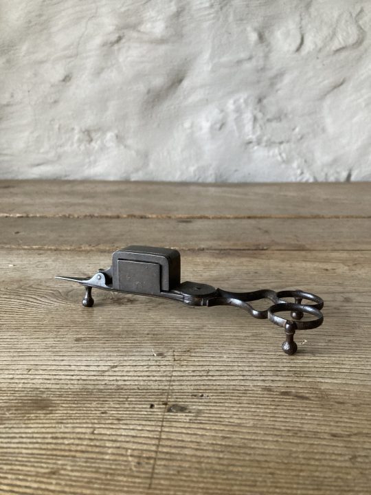 Steel candle wick trimmer.