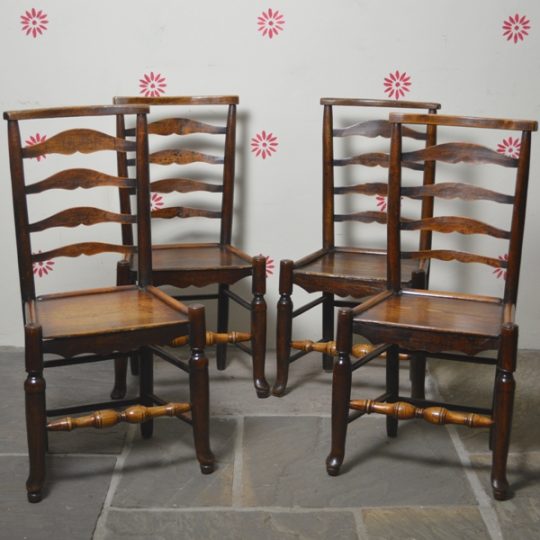 Set of four ladder-back chairs. Sold